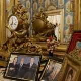 Al centro, su un ripiano in marmo, trova posto un orologio-carillon in ottone
